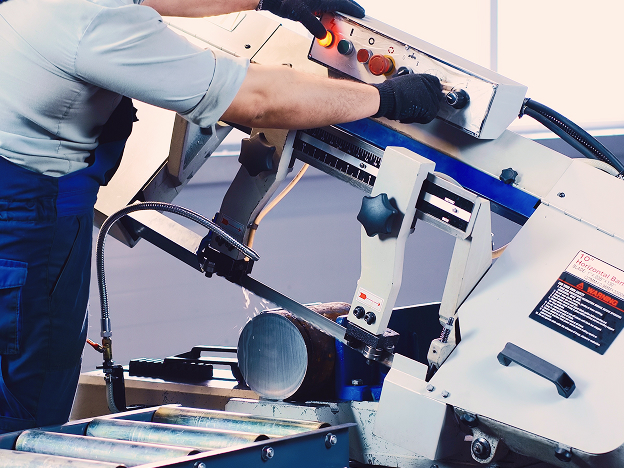 A man using a large cutting machine