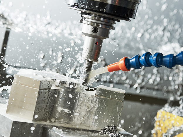 A close-up view of fluid being sprayed on a drillbit